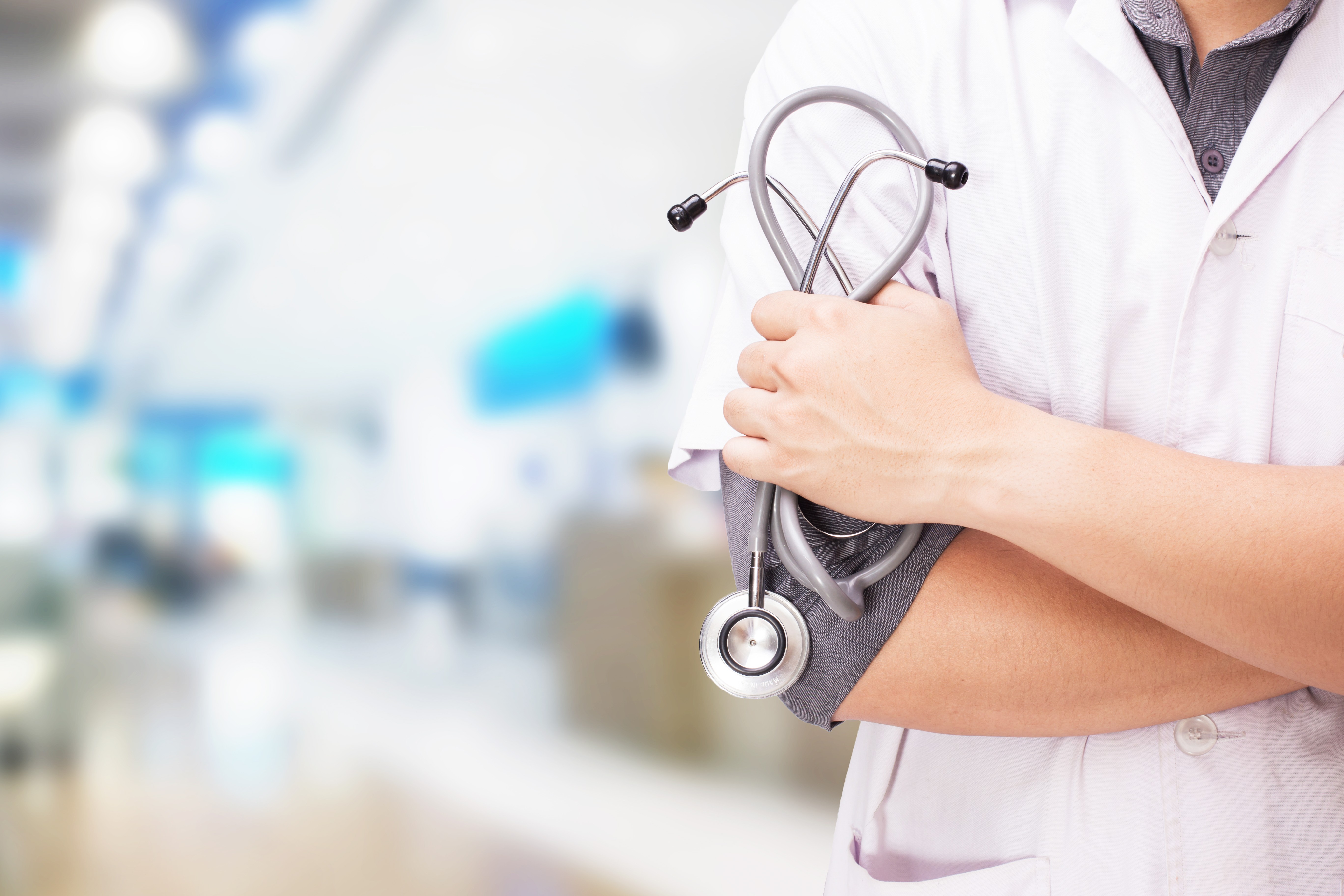 doctor-with-stethoscope-hands-hospital-background